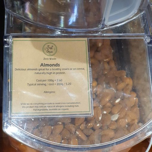 Organic almonds dispenser in the plastic free snacks and treats section Just Gaia zero waste grocery in Halifax, West Yorkshire