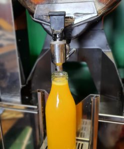 Freshly squeezed orange juice dispenser in the plastic free snacks and treats section Just Gaia zero waste grocery in Halifax, West Yorkshire