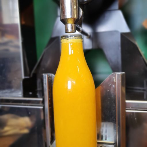 Freshly squeezed orange juice refill in the plastic free snacks and treats section Just Gaia zero waste grocery in Halifax, West Yorkshire