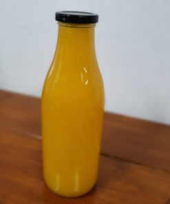 Freshly squeezed orange juice bottle in the plastic free snacks and treats section Just Gaia zero waste grocery in Halifax, West Yorkshire