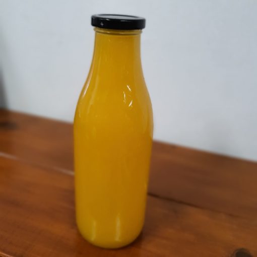 Freshly squeezed orange juice bottle in the plastic free snacks and treats section Just Gaia zero waste grocery in Halifax, West Yorkshire