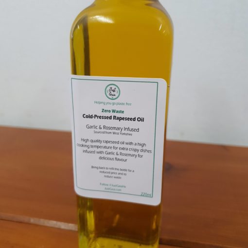 Our Just Gaia cold pressed oils. Zero waste rapeseed oil infused with rosemary and garlic close up.