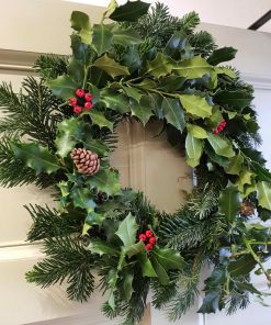 Organic handmade Christmas Wreath as part of our Christmas decorations at Just Gaia Halifax. Shown here hanging from our door.